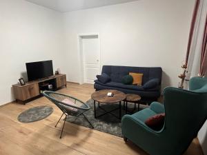 a living room with a blue couch and a table at Apartments Ejla&Una in Mostar