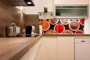 a kitchen with a counter with bowls of food at Apartment Schafbergblick mit Balkon ID 8607747 und Apartment Himmelspforte mit Balkon ID 8607779 in Mondsee