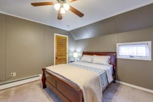 a bedroom with a bed and a ceiling fan at Maine Vacation Rental about 1 Mi to Auburn Riverwalk! in Auburn