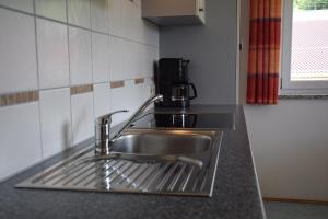 a kitchen sink with a faucet on a counter at Bauernhof Dieing in Isny im Allgäu