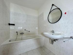 a bathroom with a sink and a tub and a mirror at Residenz am Sonnenhübel in Großschönau