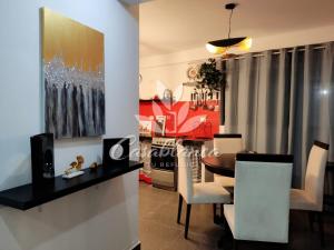 a dining room and living room with a table and chairs at Casablanca 3 in Tacna +8 photos