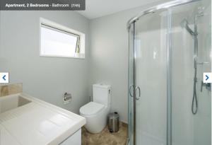a bathroom with a toilet and a glass shower at Albany Modern Private 2 bedroom 2 bathroom with Full Kitchen Netflix in Auckland +21 photos