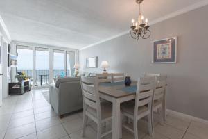 a dining room and living room with a table and chairs at Island Shores 654 in Gulf Shores