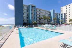 a swimming pool in front of a building at Island Shores 654 in Gulf Shores