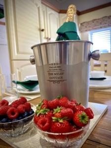 a juicer with a bowl of strawberries and a bowl of berries at The Myles' Self-Catering Cottage - 4 Stars in Greencastle
