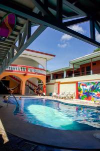 una gran piscina en un edificio con piscina en Hostel de Haan, en Jacó