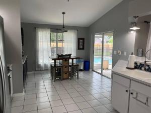 a kitchen with a table and a dining room at Southern Charm meets sunny FL fun! Home with pool and central to everything. in Cape Coral