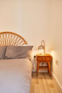 1 dormitorio con 1 cama y mesita de noche con lámpara en Binks - Seafront 1 bed first floor apartment, en Cleethorpes