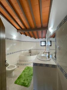 a bathroom with two sinks and a tub at Alojamento do Monte in Estremoz