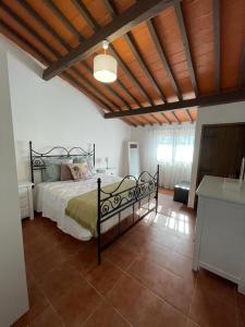 a bedroom with a bed and a wooden ceiling at Alojamento do Monte in Estremoz +55 photos