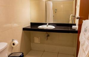 a bathroom with a sink and a mirror at Qala Hotels & Resorts in Chincha Alta