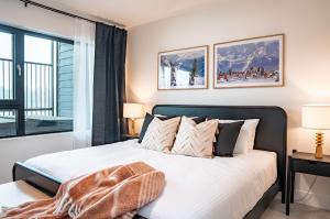 a bedroom with a large bed and a window at The Monashee House by Revelstoke Vacations in Revelstoke