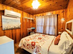 a bedroom with a bed in a wooden room at #07 - Lakeview One Bedroom Cottage-Pet Friendly in Hot Springs