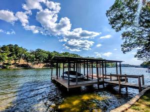 a dock on a lake with a boat on it at #07 - Lakeview One Bedroom Cottage-Pet Friendly in Hot Springs