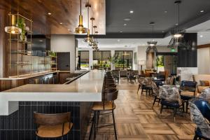 a bar in a restaurant with tables and chairs at Courtyard by Marriott Bozeman in Bozeman