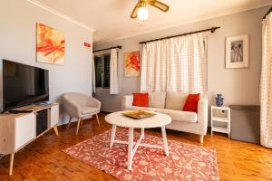 a living room with a couch and a table at Noite´s House - Prazeres in Prazeres