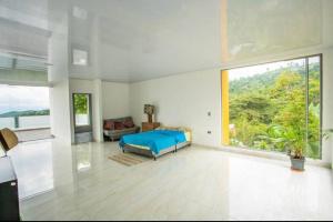 a bedroom with a bed and a large window at Espectacular Quinta privada in Viotá +80 photos