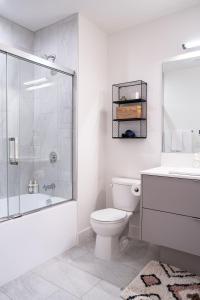 a bathroom with a toilet and a shower and a sink at The Selkirk House by Revelstoke Vacations in Revelstoke