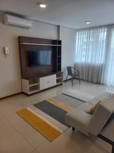 a living room with a flat screen tv and a couch at PIHARE II in Santa Cruz de la Sierra