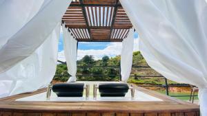 two chairs in a room with a window at Elysium Glamping in Guatapé