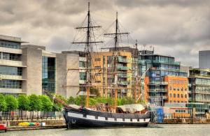 um barco sentado na água em frente a uma cidade em Hilton Garden Inn Dublin City Centre em Dublin