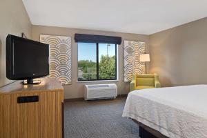 a hotel room with a bed and a flat screen tv at Hampton Inn & Suites by Hilton Walla Walla in Walla Walla