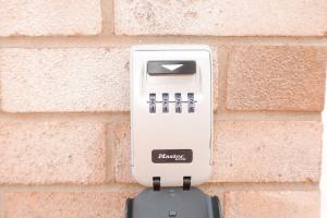 a white soap dispenser attached to a brick wall at PENZI -Spacious Studio- Free Parking- Bletchley- Contractors Welcome in Shenley Brook End