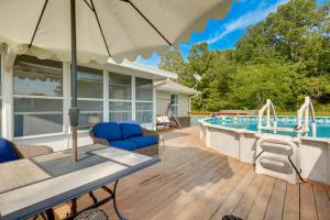 a patio with an umbrella and a swimming pool at Cozy Stafford Home with Outdoor Pool Pets Welcome! in Strafford