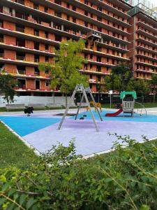 a playground in front of a large building at Sweet Home in Milano smart district in Milan