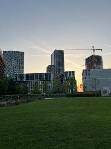 a view of a city with a field and buildings at Sweet Home in Milano smart district in Milan