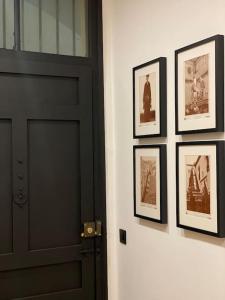 a black door with pictures hanging on a wall at NUEVO apartamento céntrico Casa Felipa in Zamora