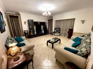 uma sala de estar com dois sofás e uma mesa em The Cozy Smoozy no Cairo