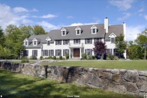 a large white house with a stone wall at 5 Plus Bedroom Over Sized Colonial in Very Private Setting in Pound Ridge
