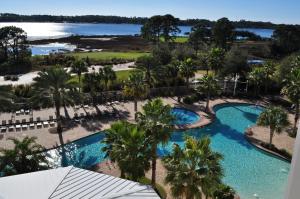 an aerial view of a resort pool with palm trees at Reflections by Panhandle Getaways in Panama City Beach