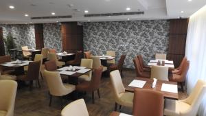 a restaurant with tables and chairs in a room at Level Nine Hotel in Jeddah