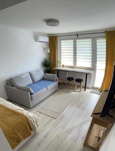 a living room with a couch and a table at Studio 2 Apartment in Ełk