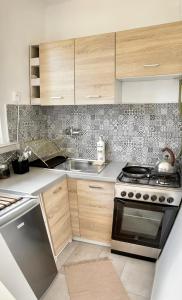a kitchen with a stove and a sink at Studio 2 Apartment in Ełk