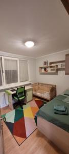 a bedroom with a bed and a desk and a desk at Central Park Apartments in Piatra Neamţ