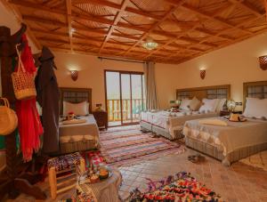 a bedroom with two beds in a room at Dar Aymane in Imlil