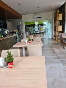 a restaurant with tables and chairs and a store at Spacious Minimalist Studio at Matina Enclaves in Davao City