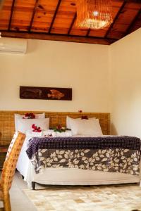 een slaapkamer met twee bedden en een houten plafond bij Ville Santorinni in Japaratinga