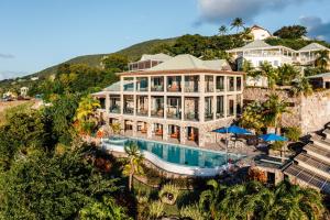 an aerial view of a large house with a swimming pool at Beautiful 3 story 8,000 sq ft Oceanside Mansion in Nevis