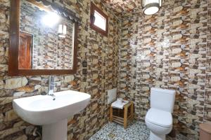 a bathroom with a sink and a toilet at Dar Aymane in Imlil