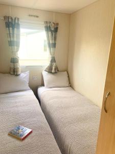 a small room with two beds and a window at The Beeches in Lincolnshire