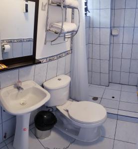a bathroom with a white toilet and a sink at Cusco de mis Sueños Hostal - II in Cusco