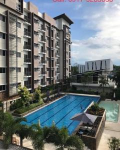 an overhead view of a swimming pool next to a building at Spacious Minimalist Studio at Matina Enclaves in Davao City