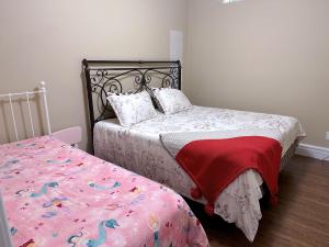 a bedroom with two beds and a bed with a bedspread at Hudson House in Vancouver