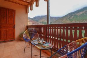 a balcony with a table and chairs on a balcony at Dar Aymane in Imlil