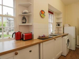 a kitchen with a counter top and a refrigerator at Rose Cottage in Melrose